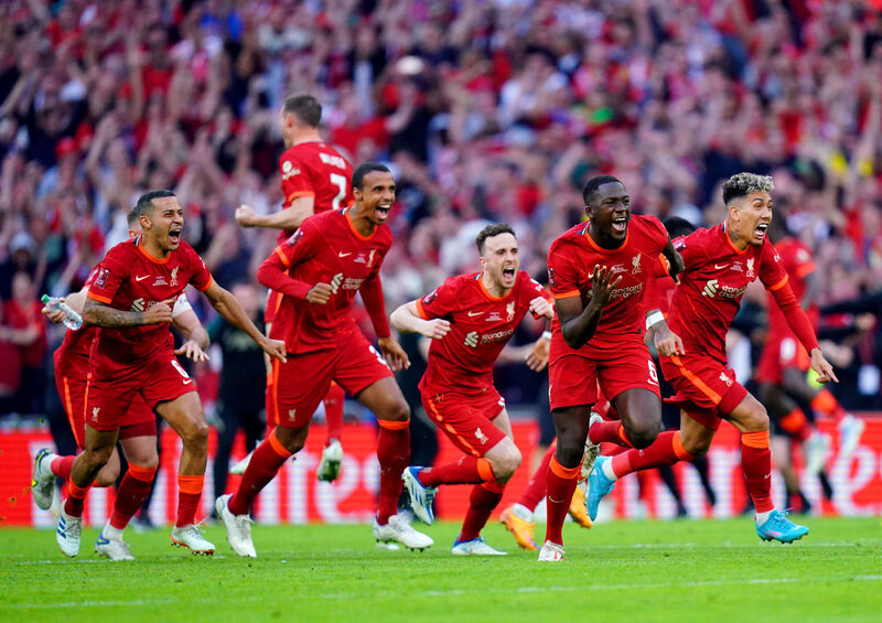 Liverpool players celebrate after team-mate Kostas Tsimikas (not pictured) scores the winning penalty of the Emirates FA Cup final at Wembley Stadium, London on  May 14, 2022. Picture: Adam Davy/PA Wire.