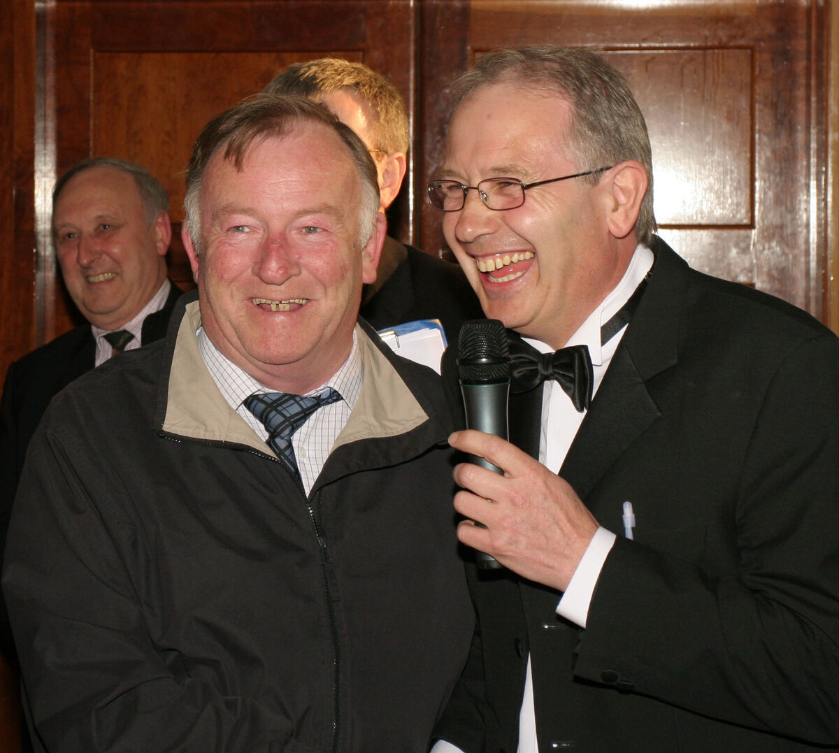 The late Jim Forbes is led into the room by MC Paudie Palmer at a 'This is Your Life' event for Jim in The Rochestown Park Hotel in 2006. Picture: Kieran Boyde