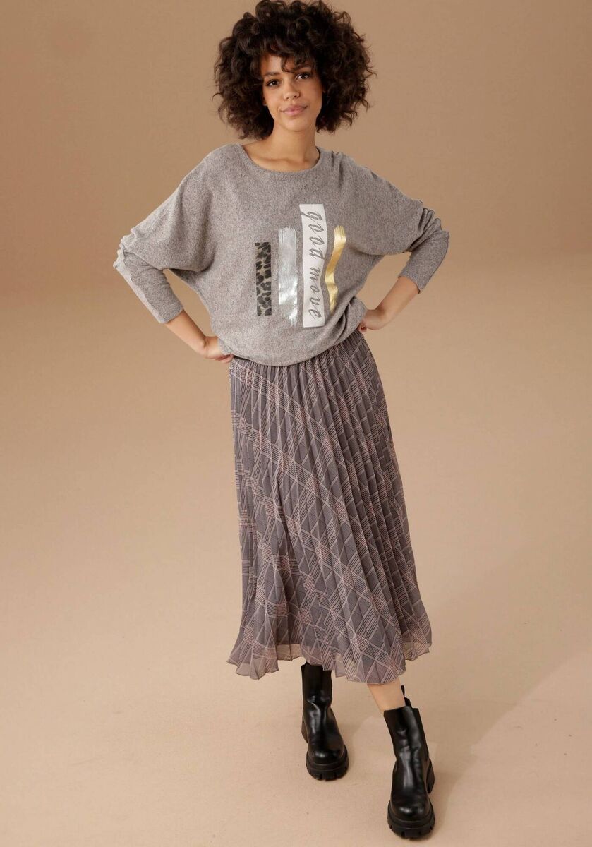 Undated Handout Photo of Sweatshirt, Aniston Casual Checked Pleated Skirt, available from Freemans (boots, stylist's own). Undated Handout Photo of Sweatshirt, Aniston Casual Checked Pleated Skirt, available from Freemans (boots, stylist's own).
