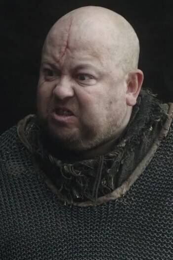 Ciaran playing Mord in Game of Thrones.