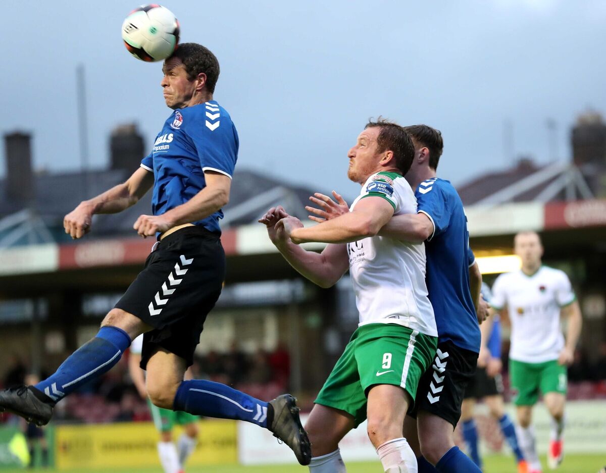 Achille Campion, Cork City FC, battles Kieran O'Mahony and Evan Murphy, Wilton United. Picture: Jim Coughlan.