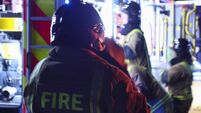 Firefighters taking equipment from fire truck and preparing