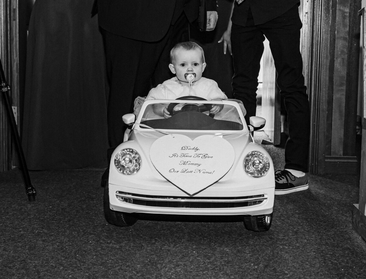 Freya going down the aisle in the white VW Beetle.