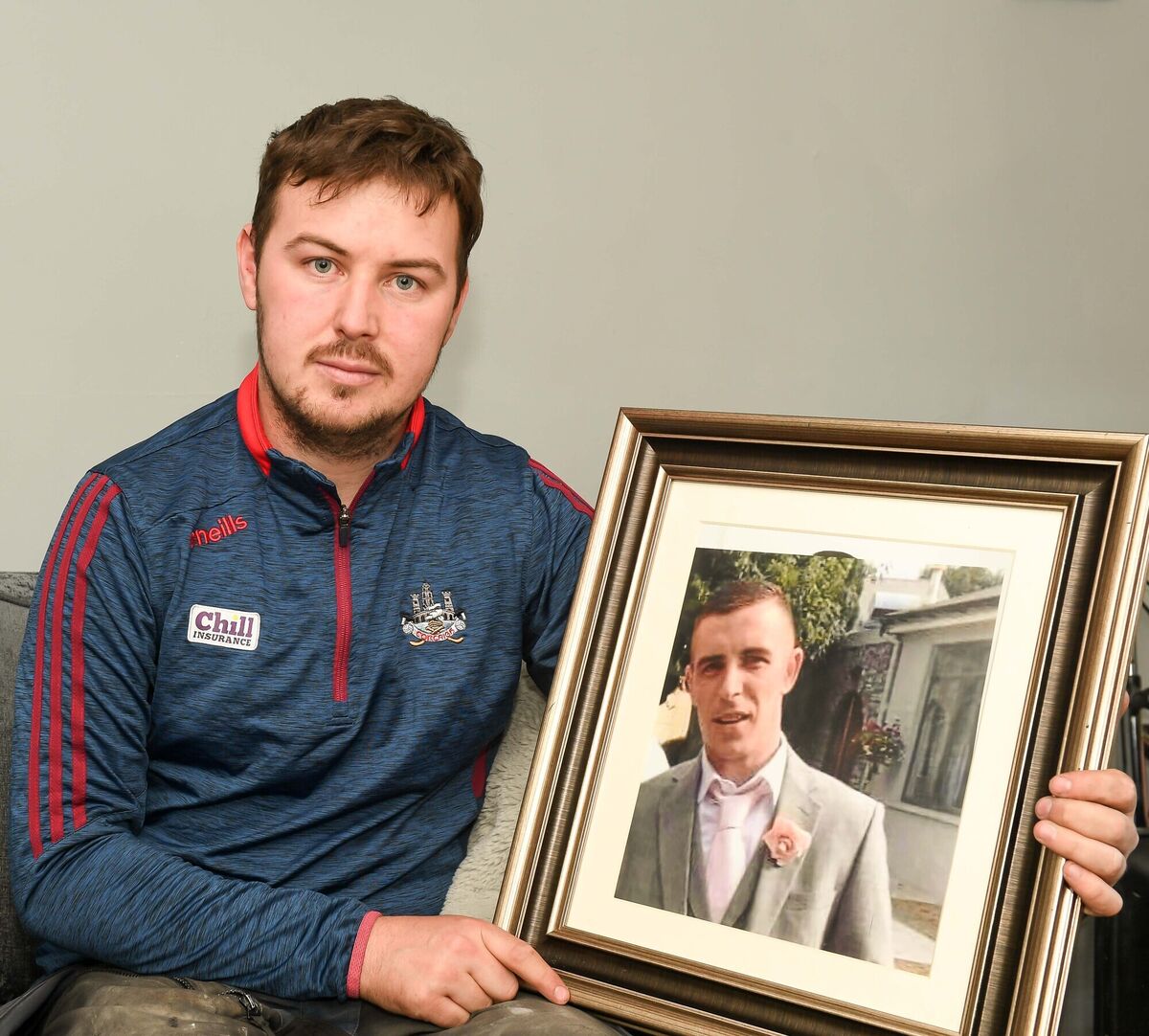 Evan Gearns holding a picture of his deceased brother Andrew. Evan Gearns holding a picture of his deceased brother Andrew.