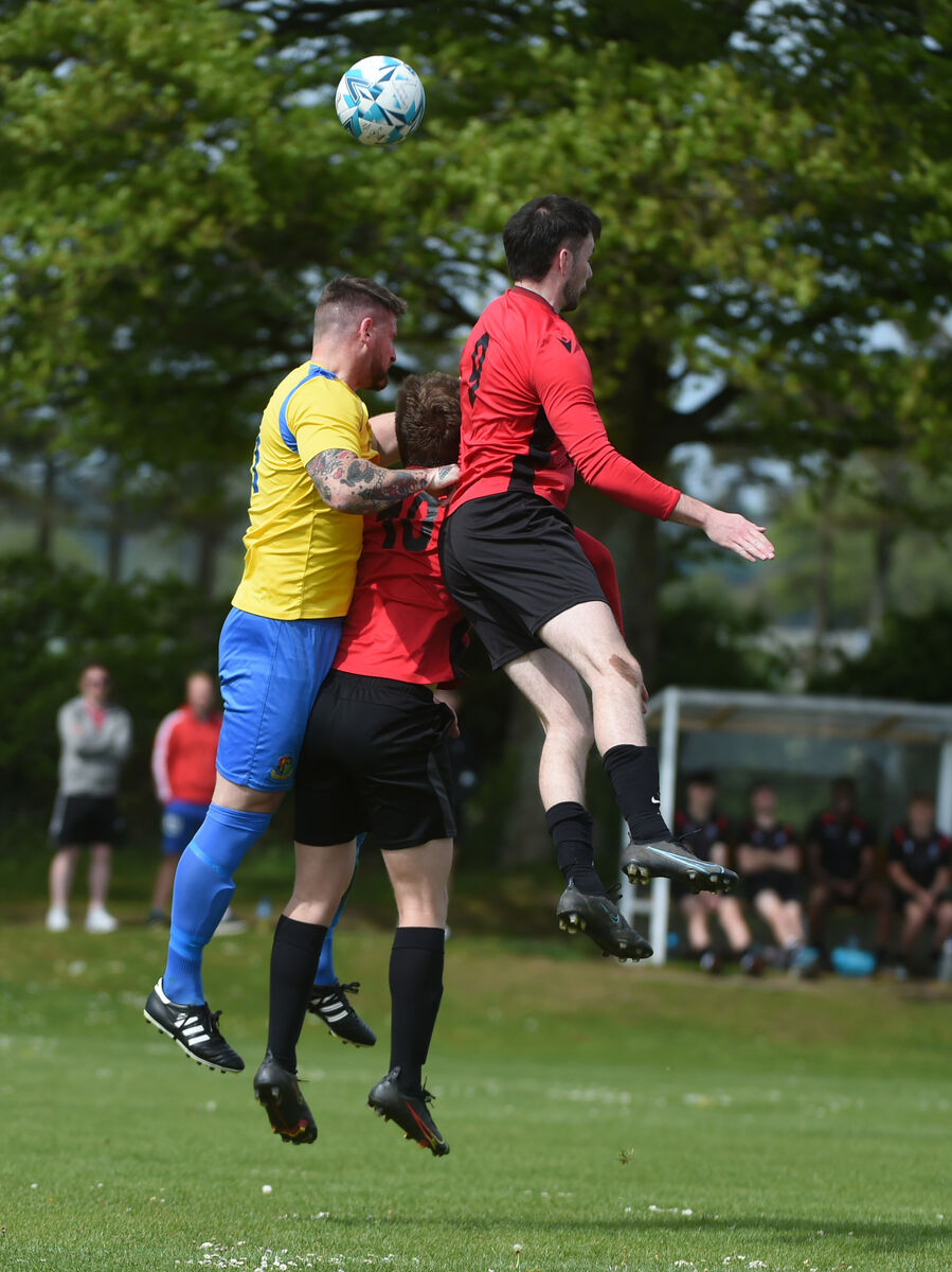  Kalen Spillane, Carrigaline in the air against Douwe Van Sinderen and Michael Fahy of UCC.