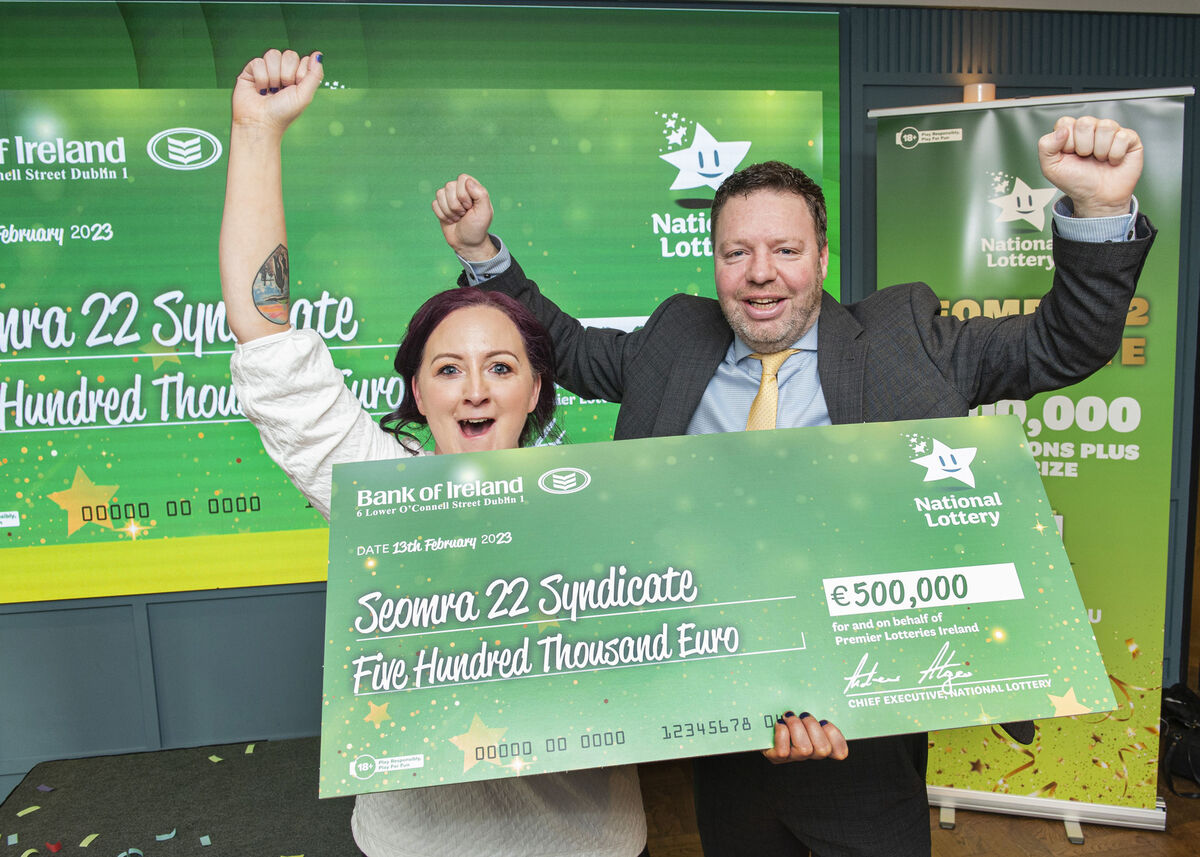 Rebecca Walsh and Ronan Cooney claims manager Lotteries Ireland Holding the winning cheque
