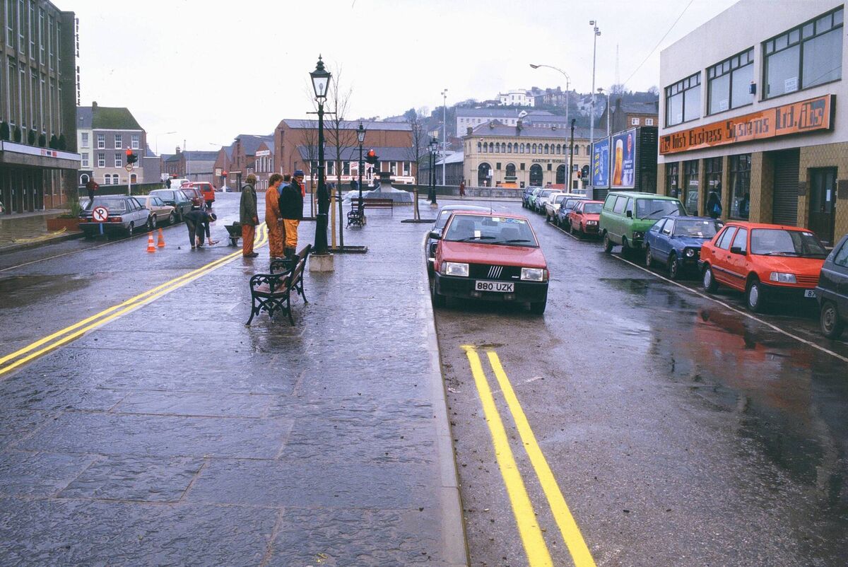 Richard Mills' Fiat parked legally before the double yellow lines were painted, but then ticketed in Emmet Place, with the workmen waiting to finish off the job. Picture: Richard Mills. Richard Mills' Fiat parked legally before the double yellow lines were painted, but then ticketed in Emmet Place, with the workmen waiting to finish off the job. Picture: Richard Mills.