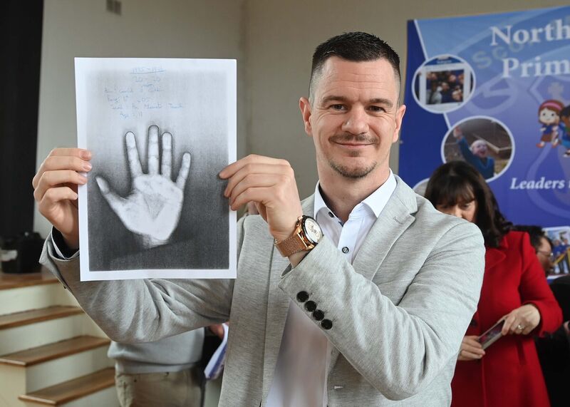 Gary Coughlan with a sketch of his hand which was among the memorabilia from a time capsule from 1995-1996 which was opened by the former sixth class pupils from the time and family members and Herman Kemp, who was the sixth class teacher then, at North Monastery Primary School, Cork. Gary Coughlan with a sketch of his hand which was among the memorabilia from a time capsule from 1995-1996 which was opened by the former sixth class pupils from the time and family members and Herman Kemp, who was the sixth class teacher then, at North Monastery Primary School, Cork.