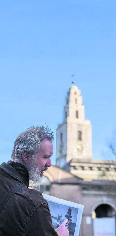 Ronan showing an old photo of children playing in the streets of Cork City. Ronan showing an old photo of children playing in the streets of Cork City.