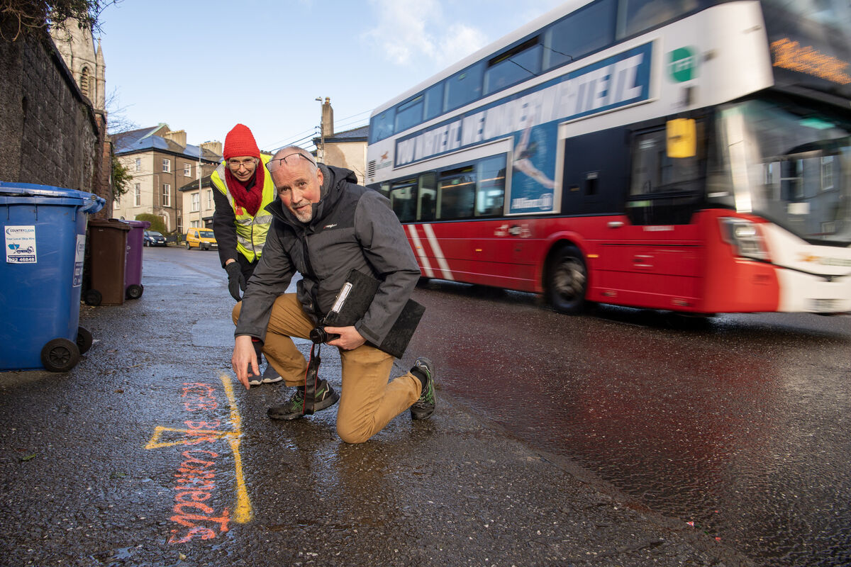  Residents of Summerhill North, Cork Mary Mangan and Hugh Lorigan at the yellow line showing the part of the footpath which couldbe taken away when the new BusConnects corridor is introduced. Picture Dan Linehan