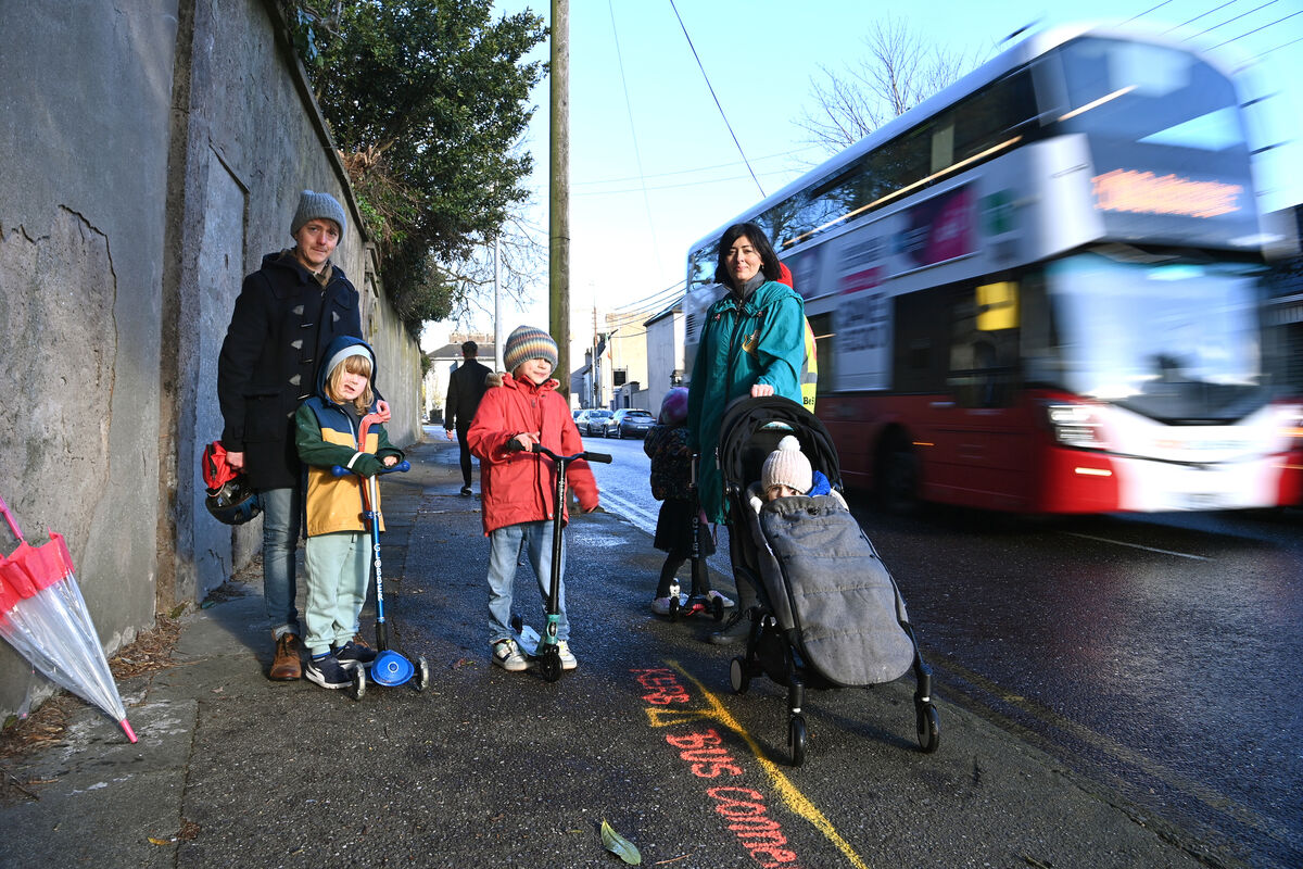  Residents of Summerhill North, Cork David and Charlie Murphy with Valerie Kent and her children Finn, Laoise and Jessie standing at the yellow line showing part of the footpath which may be taken away when the new BusConnects corridor is introduced. Picture Dan Linehan