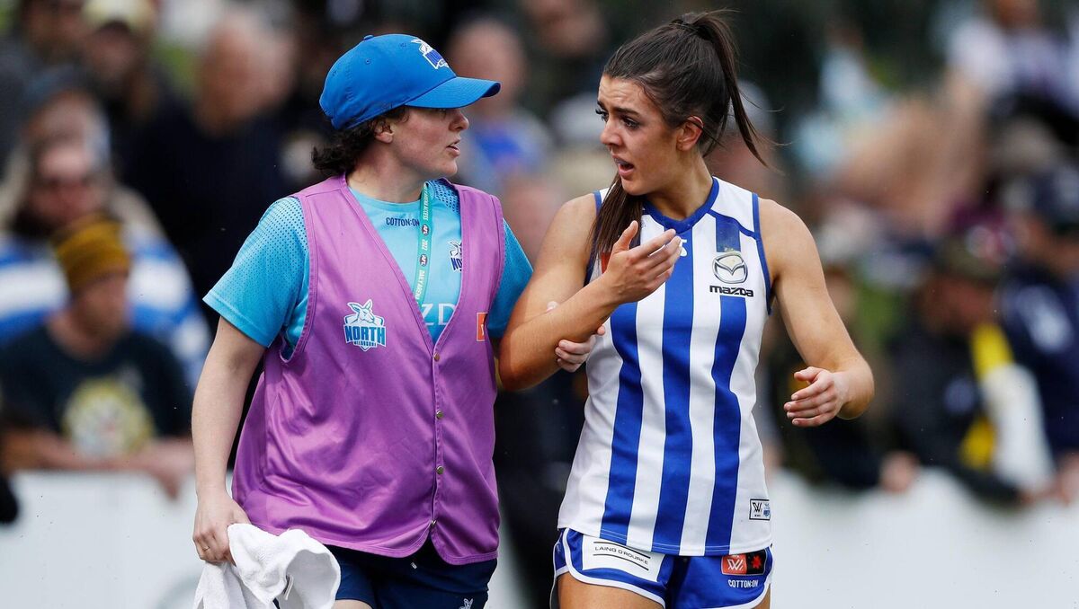 Erika O'Shea of the Kangaroos leaves the field with medical staff. Picture: Dylan Burns/AFL Photos via Getty Images Erika O'Shea of the Kangaroos leaves the field with medical staff. Picture: Dylan Burns/AFL Photos via Getty Images