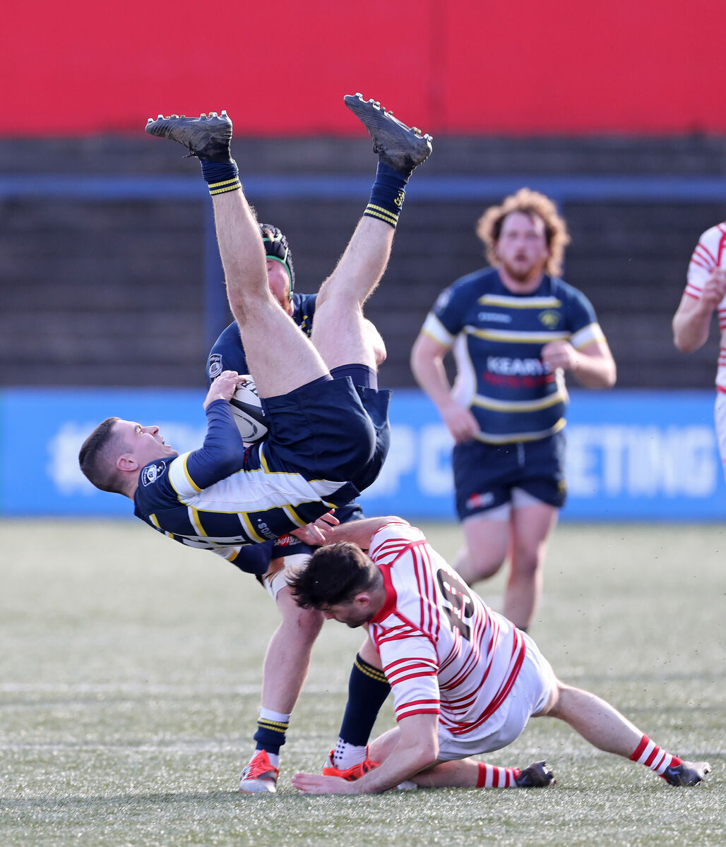  Alex Pope, Dolphin, is tackled in the air by Cian Ryan, Nenagh Ormond, resulting in a yellow card for the Nenagh Ormond player. Picture: Jim Coughlan.