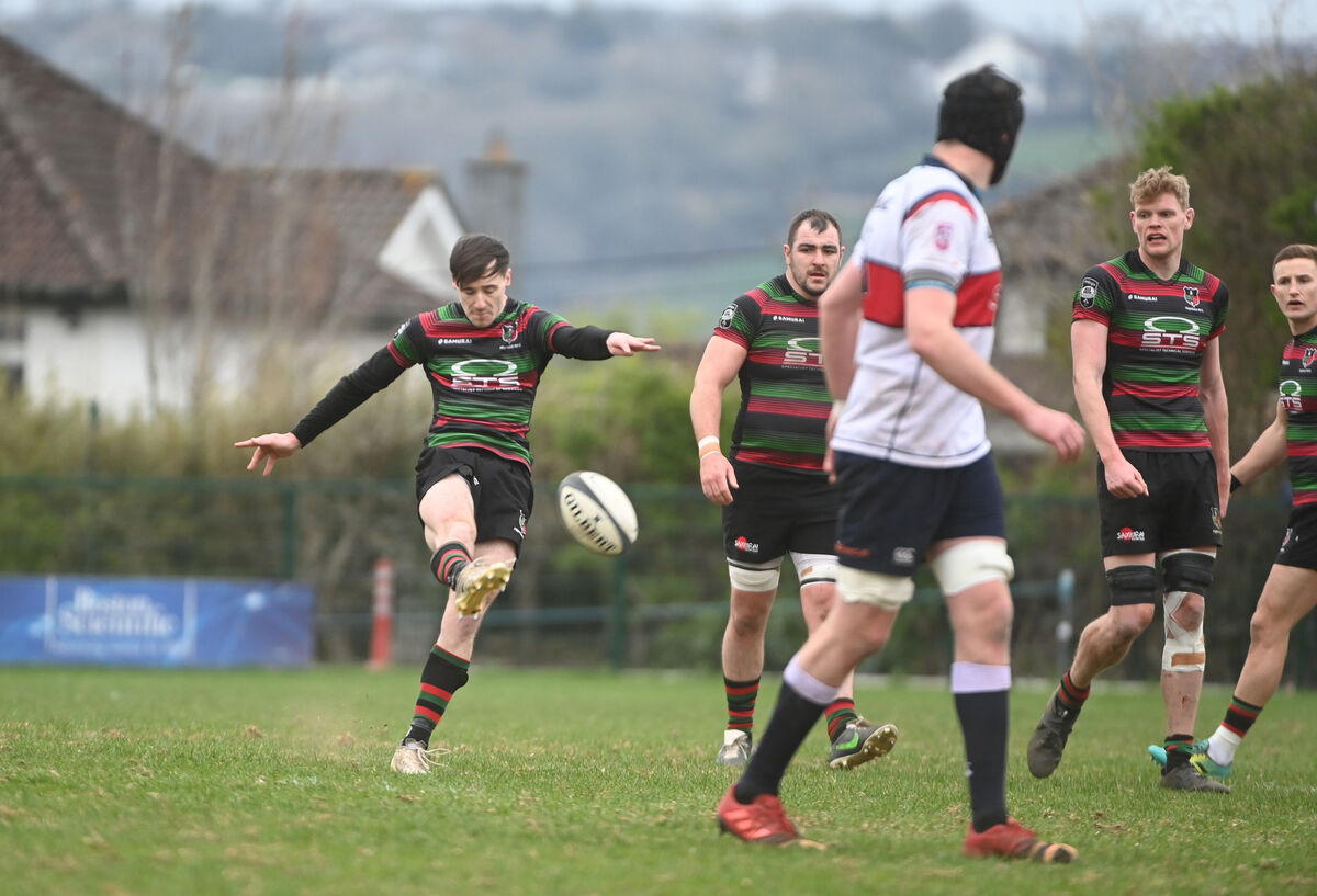 Highfield out-half James Taylor kicks upfield against Old Wesley. Pic: Larry Cummins