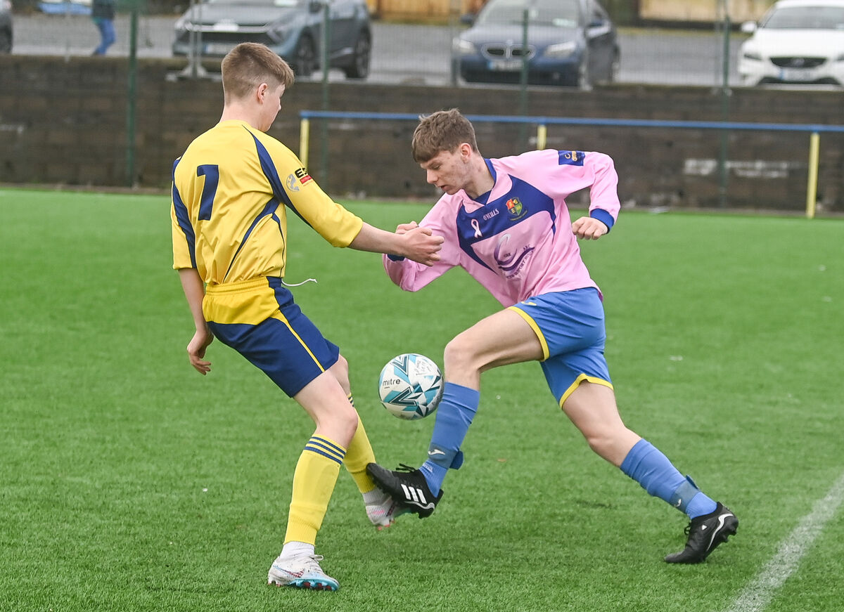  Douglas Hall's Sean Morrissey in a tussle with Carrigaline United's Jack Mangan. Picture: David Keane.