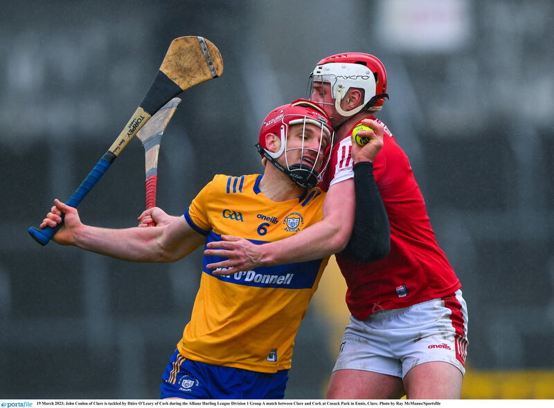 John Conlon of Clare is tackled by Dáire O’Leary of Cork. Picture: Ray McManus/Sportsfile John Conlon of Clare is tackled by Dáire O’Leary of Cork. Picture: Ray McManus/Sportsfile