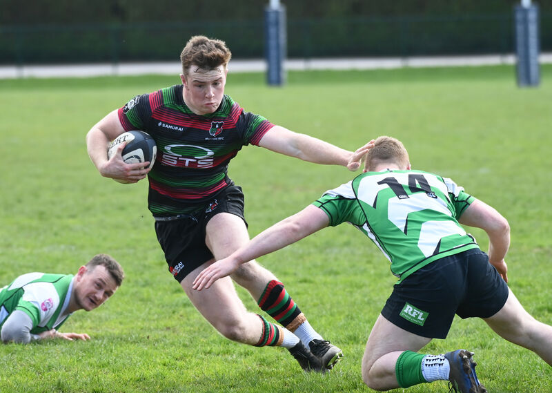 Highfield's Liam McCarthy holds off Naas winger Donal Conroy. Picture: Eddie O'Hare
