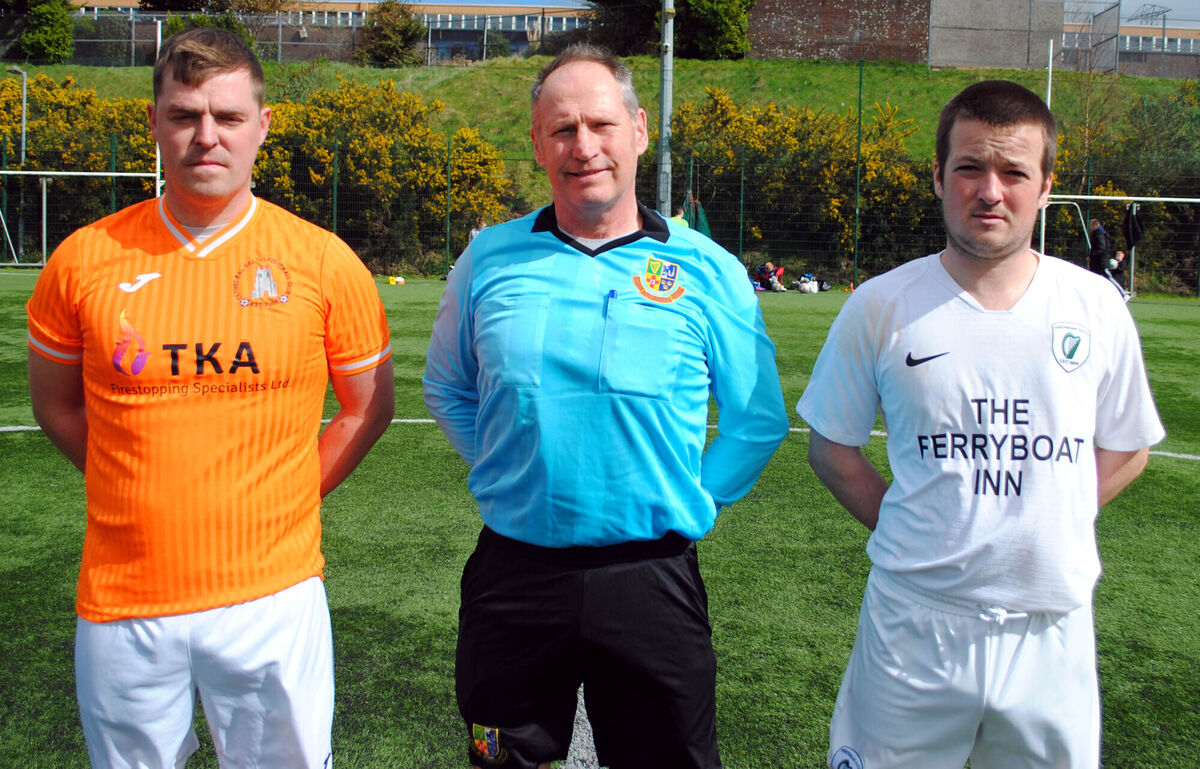Cathedral Celtic's Johnny Sullivan (left) with Hibenians' Dean Cronin, accompanied by referee Steven Madine. Picture: Barry Peelo.