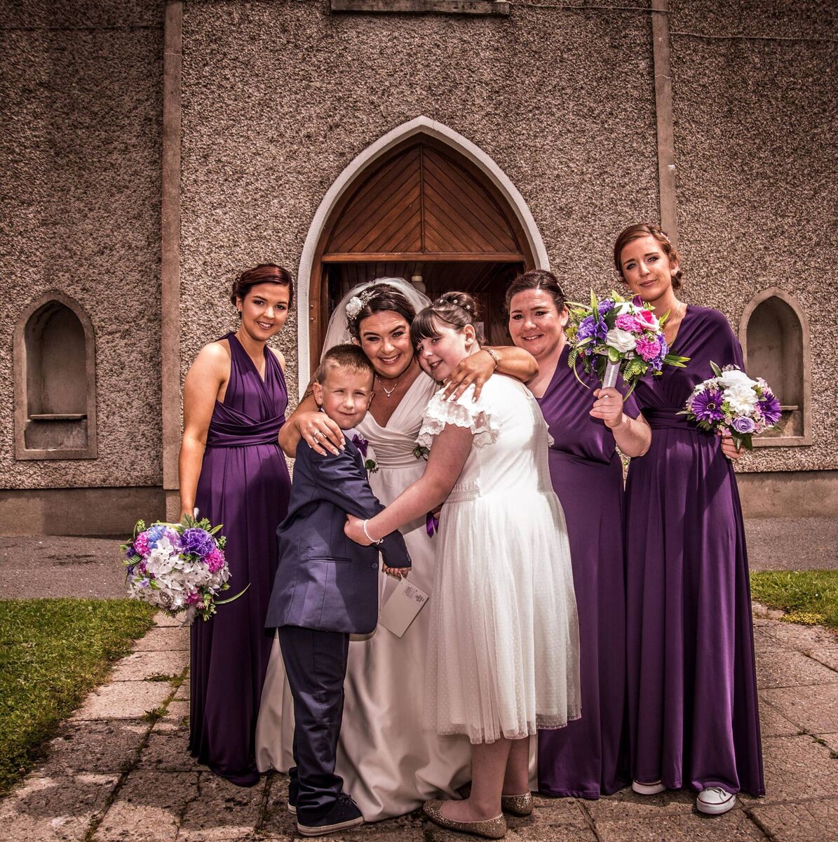 The bride with her wedding party outside St Joseph’s Catholic Church where they were married.