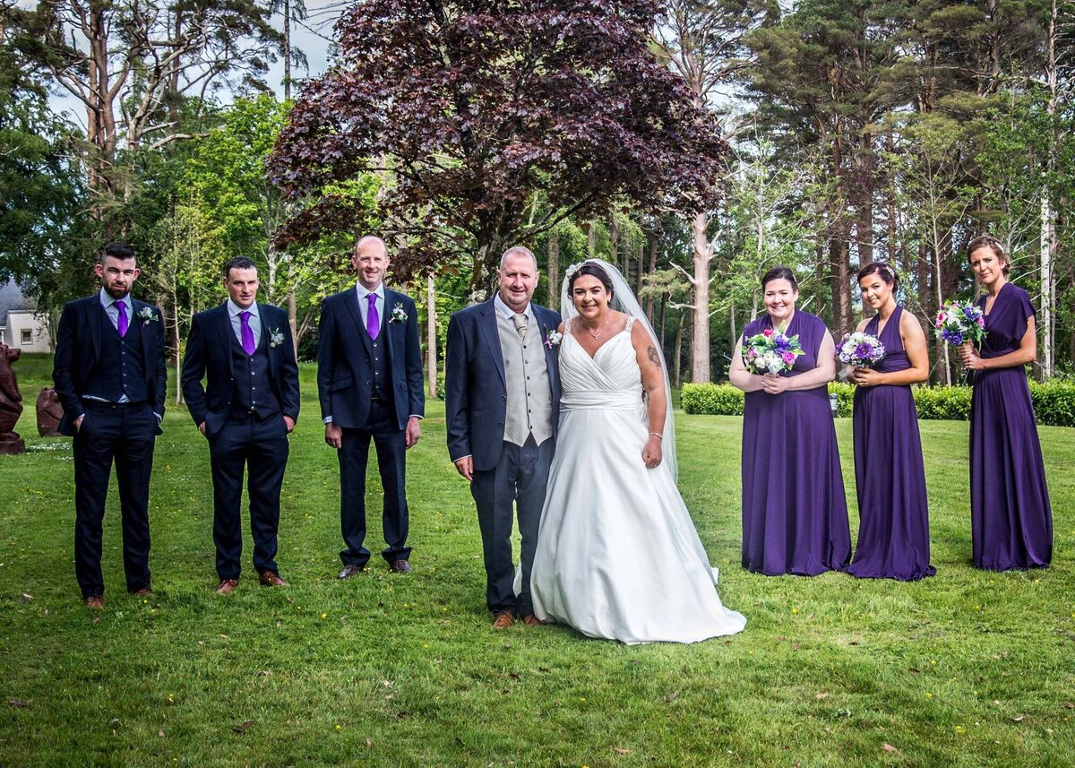 The wedding party with the happy couple, who first dated in school, more than 19 years ago.