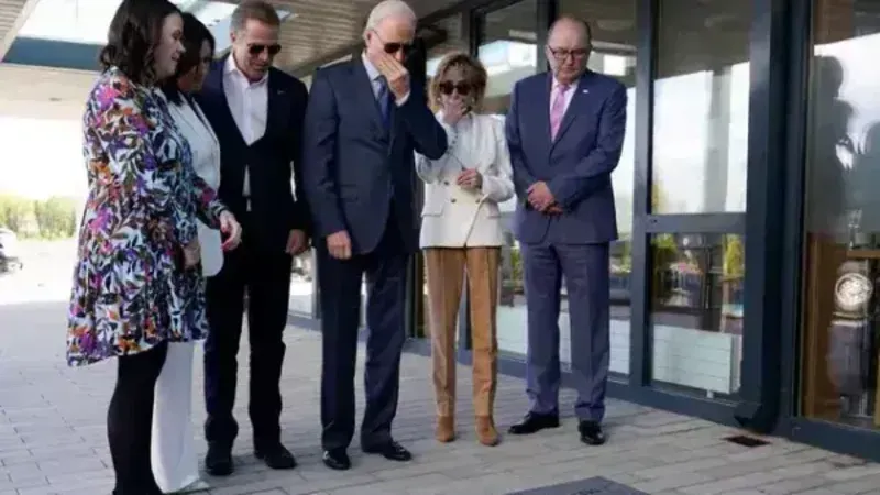 Biden looks at plaque in memory of late son and meets distant cousin at hospice