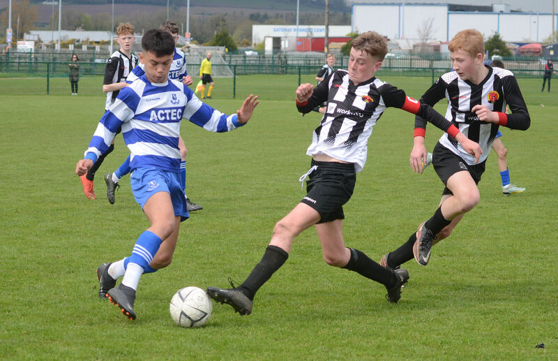 Midleton's Charlie McCarthy clashes with Lions FC's Sean Dempsey. Picture: Howard Crowdy