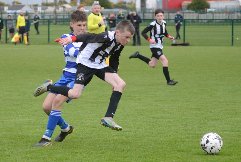 Midleton's Alex Wilson skips past a challenge from Lions FC's Danny Campion. Picture: Howard Crowdy