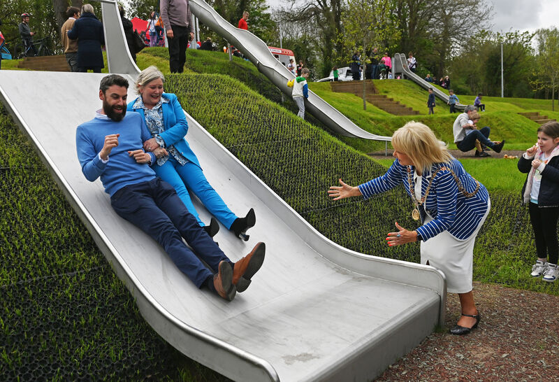 The Lord Mayor of Cork Cllr Deirdre Forde watches as Ann Doherty CEO Cork City council and Paul McGartoll, National transport authority try out the slides at the opening of phase one of the Marina to Passage West Greenway , included park area. Picture; Eddie O'Hare