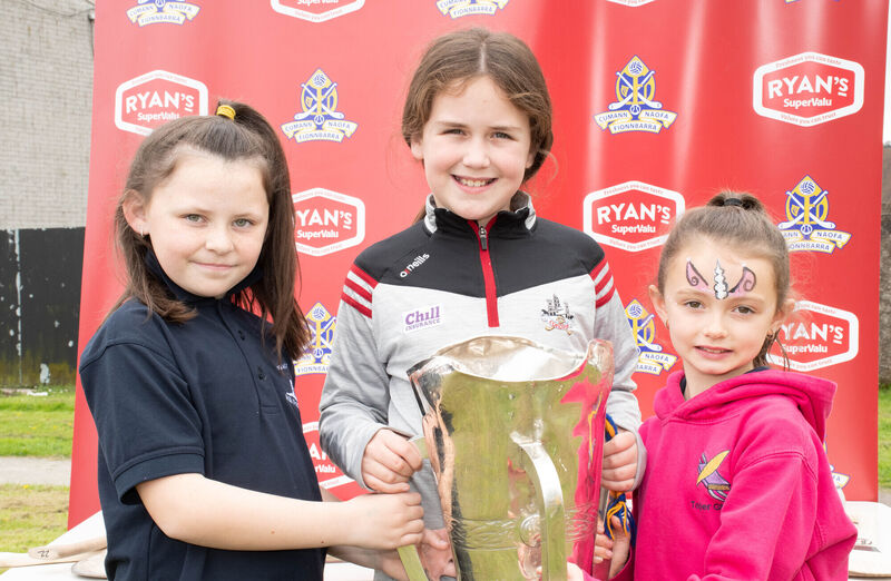 Brooke Kiely, Kate Minihane and Emily Milner pictured with the County Senior Hurling Championship trophy at the Togher Family Centre event. Pic: Howard Crowdy
