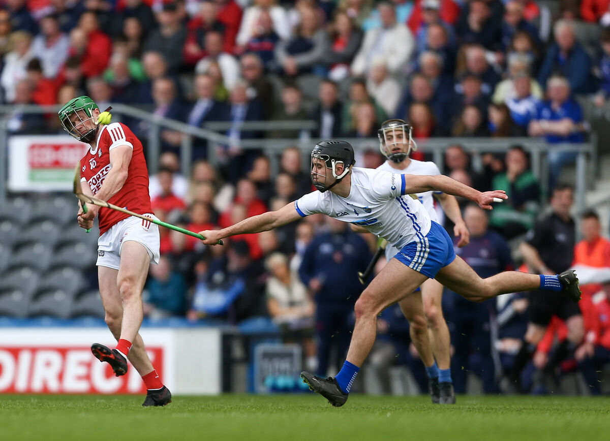 Cork’s Seamus Harnedy scores a points despite pressure from Waterford’s Mark Fitzgerald. Pic: INPHO/Ken Sutton
