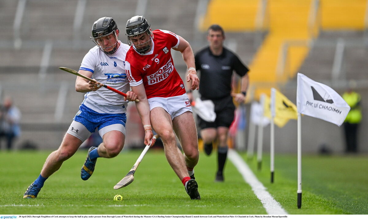 Darragh Fitzgibbon of Cork attempts to keep the ball in play under pressure from Darragh Lyons of Waterford. Picture: Brendan Moran/Sportsfile
