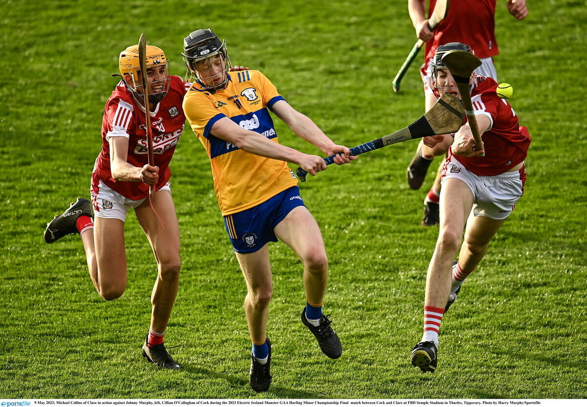Michael Collins of Clare in action against Johnny Murphy, left, Cillian O'Callaghan of Cork during the 2023 Electric Ireland Munster GAA Hurling Minor Championship Final match between Cork and Clare at FBD Semple Stadium in Thurles, Tipperary. Photo by Harry Murphy/Sportsfile
