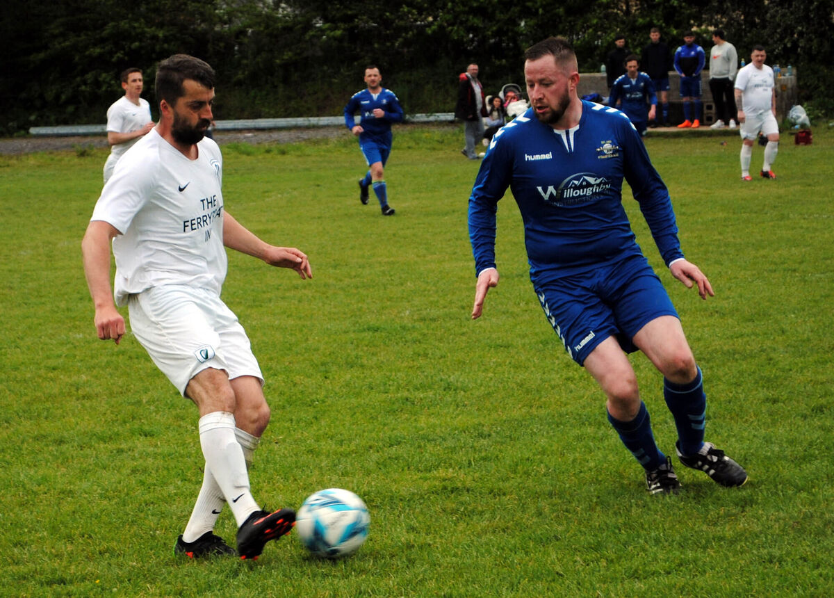 Hibs' Aaron Hickey gets his pass away before Strand's Jamie Lynch could close in.