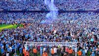 Manchester City players and fans celebrate step one of the treble
