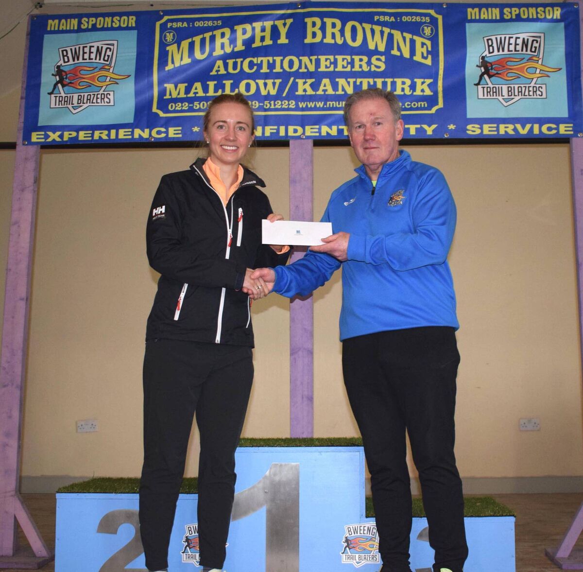 Niamh Moore, first in the women's race at the Bweeng 5km, receiving her prize from Patrick Murphy of Murphy Browne Auctioneers, main race sponsor. Picture: John Walshe Niamh Moore, first in the women's race at the Bweeng 5km, receiving her prize from Patrick Murphy of Murphy Browne Auctioneers, main race sponsor. Picture: John Walshe