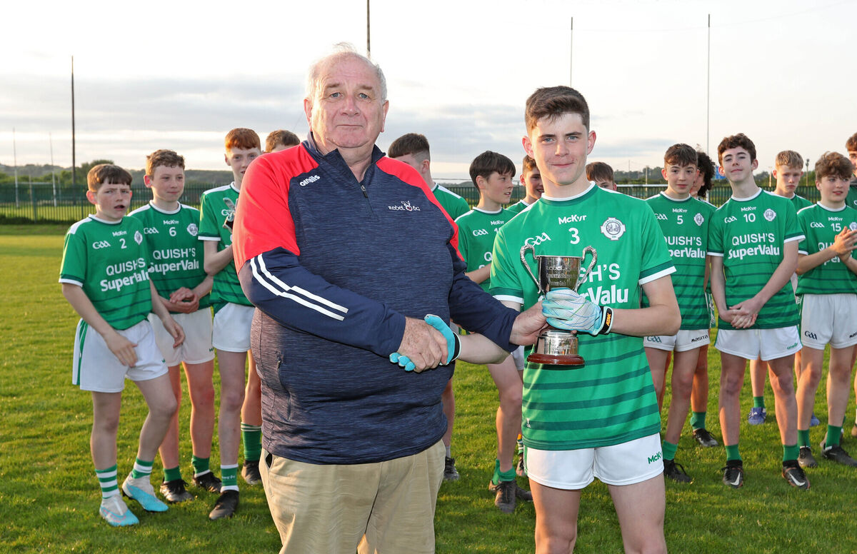  Eoghan O'Connor, Rebel Óg, presents the cup to Luke Higgins, Ballincollig captain. Picture: Jim Coughlan