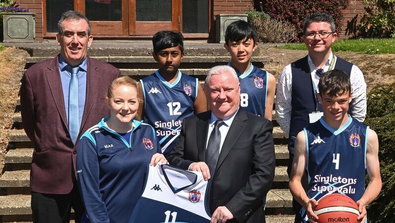 Tomás Singleton of Singleton's SuperValu at the presentation of two new sets of basketball jerseys to North Monastery Co-educational Secondary School, Cork, with Margaret Ann Kehoe, basketball coach; Jim Boyle, acting principal, (back left); Shane Ryan, fundraising co-ordinator, and school team members Aidan Spence Murphy (front), Aaron Jose (back second left) and Ysmael Garilao.