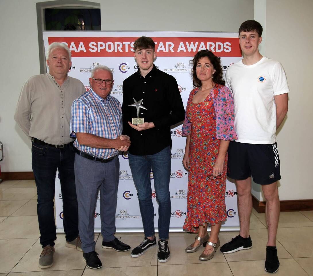 Eoin Downey and his family collecting the 96FM/C103 GAA Sports Star Award from Finbarr McCarthy.