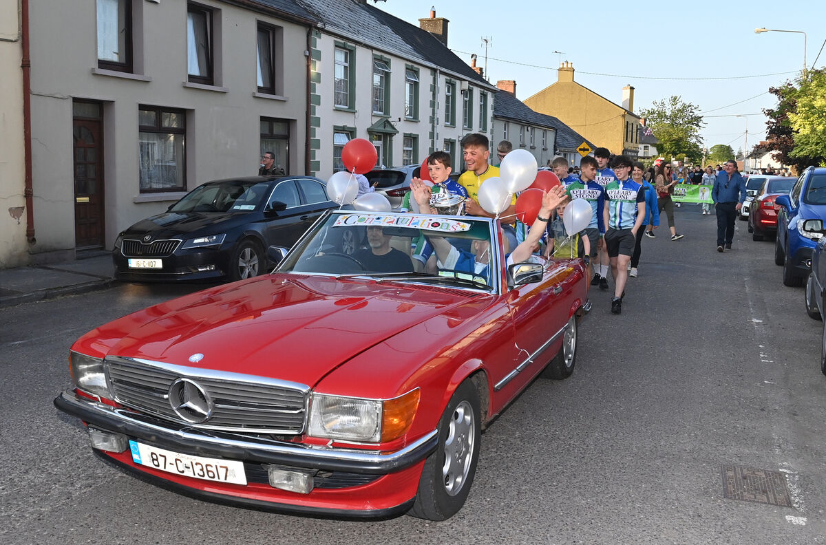Young Gavin Buckley with Dillon Corkery, the Rás Tailteann 2023 winner, leading the victory parade through Banteer. Young Gavin Buckley with Dillon Corkery, the Rás Tailteann 2023 winner, leading the victory parade through Banteer.