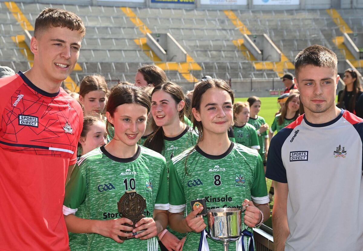 Belgooly's Evelyn Rath and Ciara Dumigan after being presented with Sciath na Scol trophies by Cork U20 hurlers Ben Cunningham and William Buckley. Picture: Denis Minihane. Belgooly's Evelyn Rath and Ciara Dumigan after being presented with Sciath na Scol trophies by Cork U20 hurlers Ben Cunningham and William Buckley. Picture: Denis Minihane.