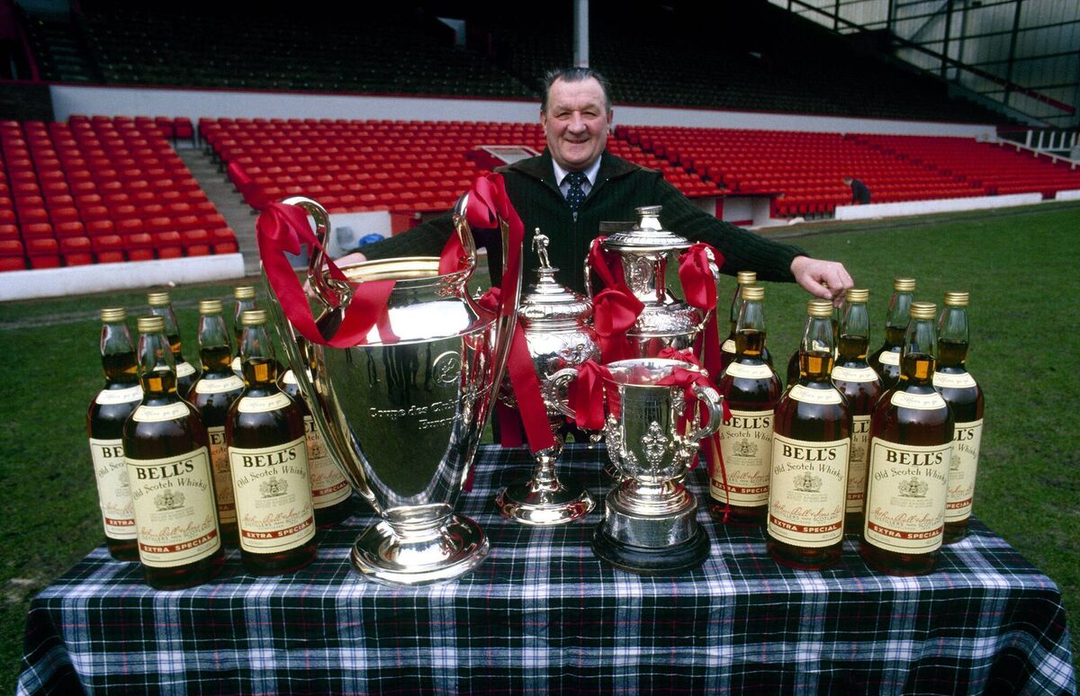 Liverpool manager Bob Paisley stands on the Anfield pitch, proudly displaying his haul from the 1980-81 season. Picture: Liverpool FC via Getty Images