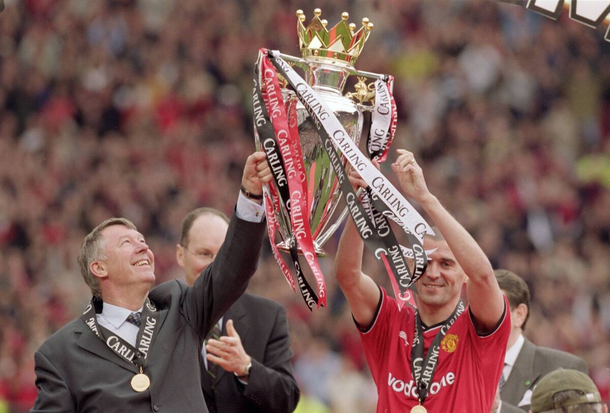 Manchester United manager Alex Ferguson and captain Roy Keane lift the trophy and celebrate being crowned Premier League champions