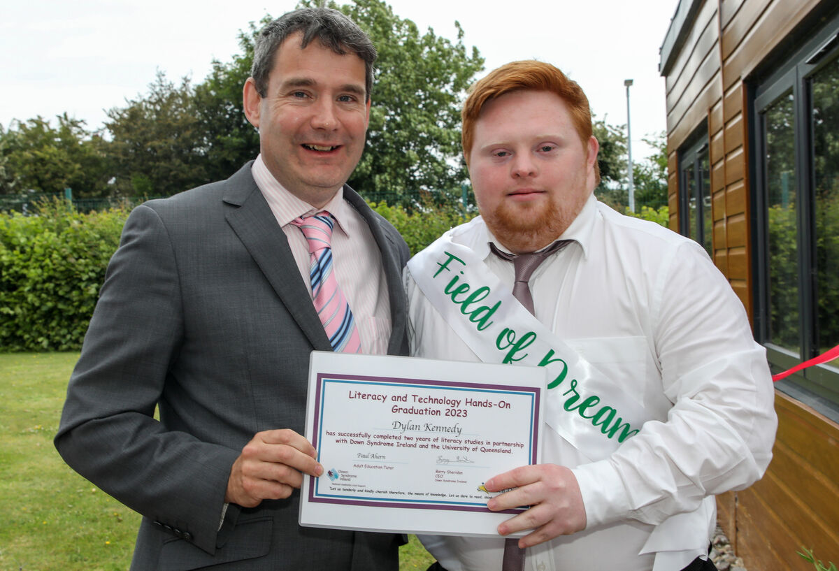 Dylan Kennedy receives his certificate from John Condon, Down Syndrome Ireland at a graduation ceremony for the Literacy and Technology programme at the Down Syndrome Cork Field of Dreams, Curraheen, Cork. - Picture; David Creedon