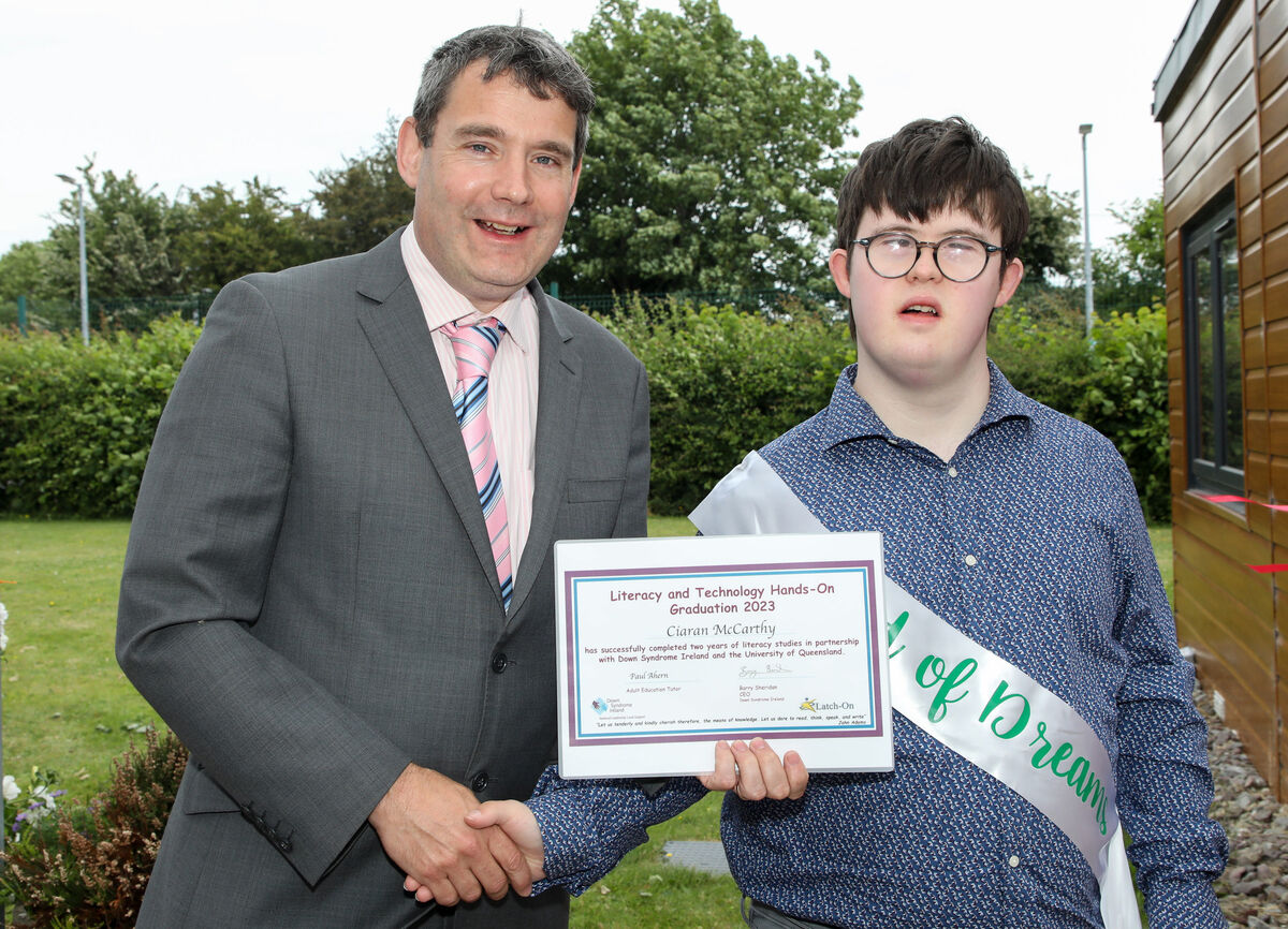 Cíaran McCarthy receives his certificate from John Condon, Down Syndrome Ireland at a graduation ceremony for the Literacy and Technology programme at the Down Syndrome Cork Field of Dreams, Curraheen, Cork. - Picture; David Creedon