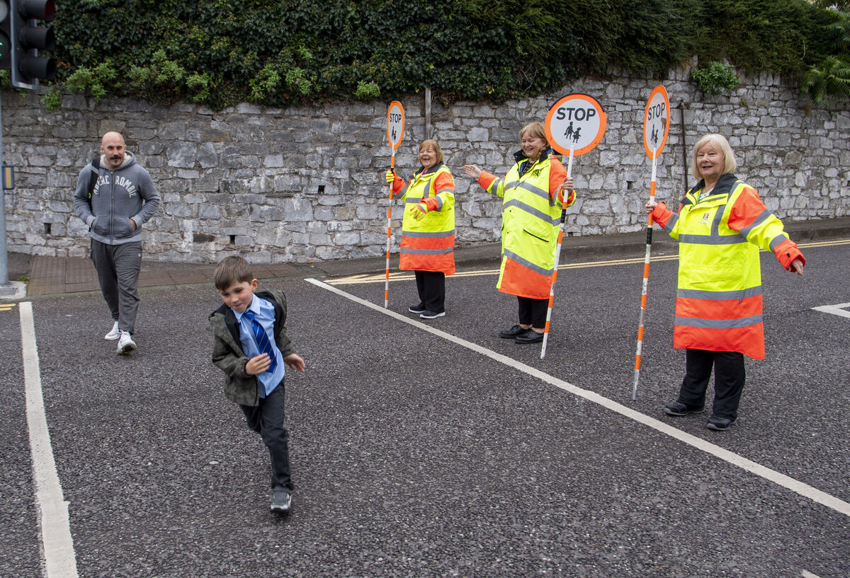  Irish professional boxer Spike O'Sullivan and his son Tommy crossing the road as they leave the Glasheen Boys national School with the help of the School warden sisters, Margaret, Deirdre ande Jean Picture: Dan Linehan