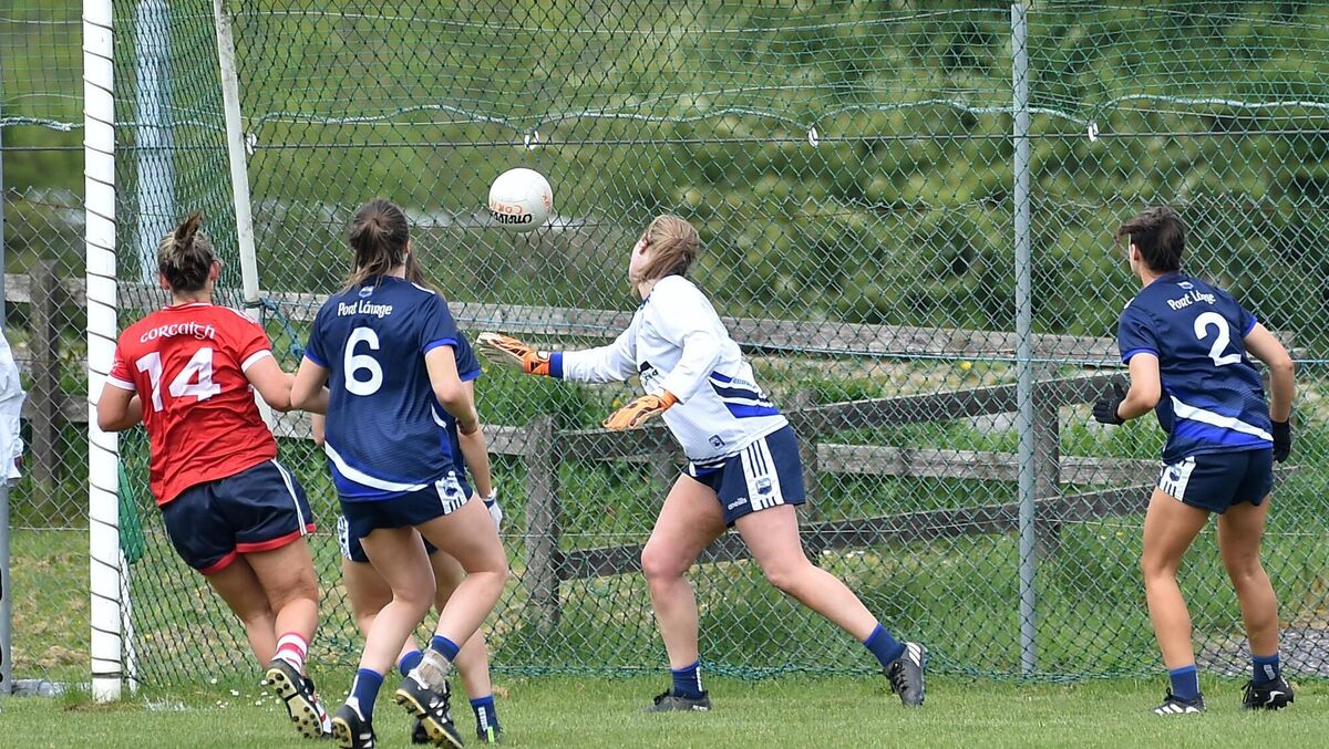 Doireann O'Sullivan puts the ball in the back of the net despite the best efforts of Waterford keeper Evelyn O'Brien. Picture: Dan Linehan