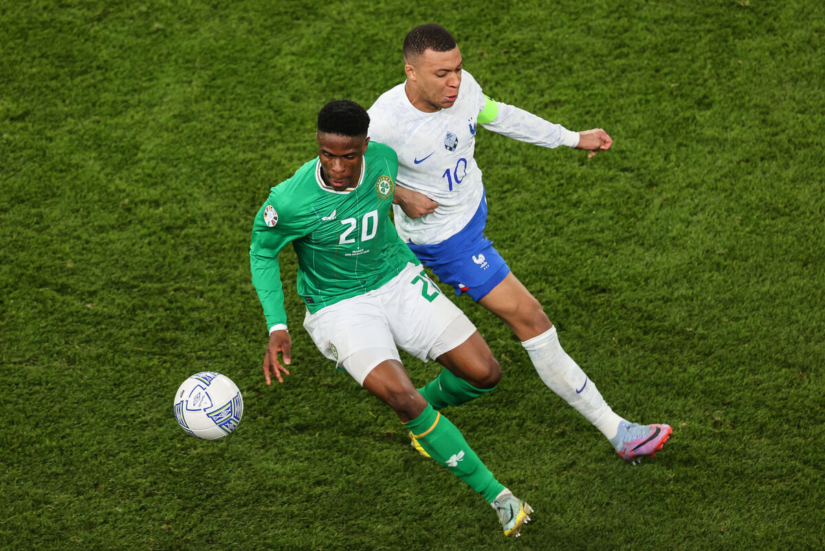 Ireland’s Chiedozie Ogbene battling France's Kylian Mbappé back in March. Unfortunately, the Corkman is out injured for the coming match against Gibraltar Picture: INPHO/Ben Brady