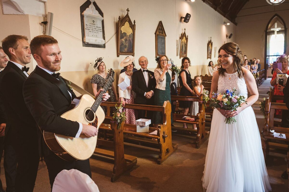 The special moment when Theresa Nyhan walked towards her husband-to-be at Ardfield Church. John surprised her by playing ‘Here Comes The Sun’ on his guitar. Picture: Dermot Sullivan