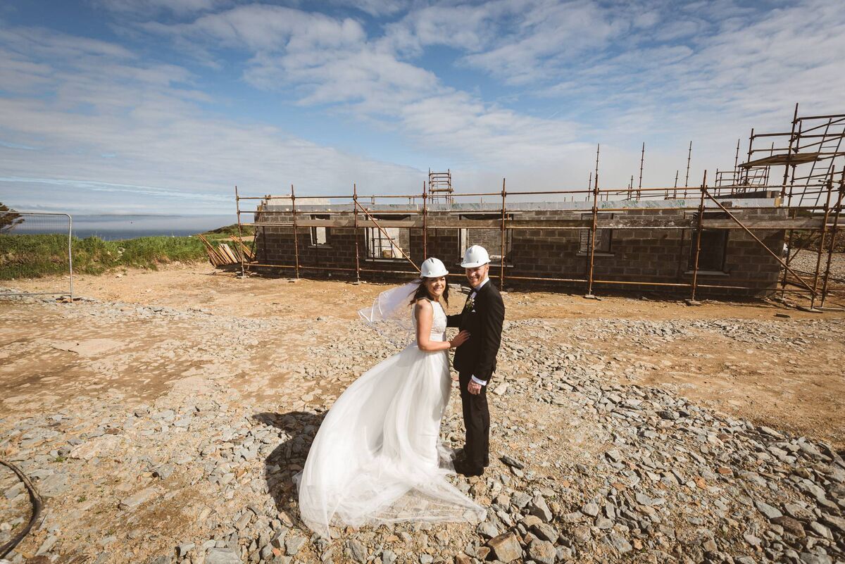 At the site of their new home.