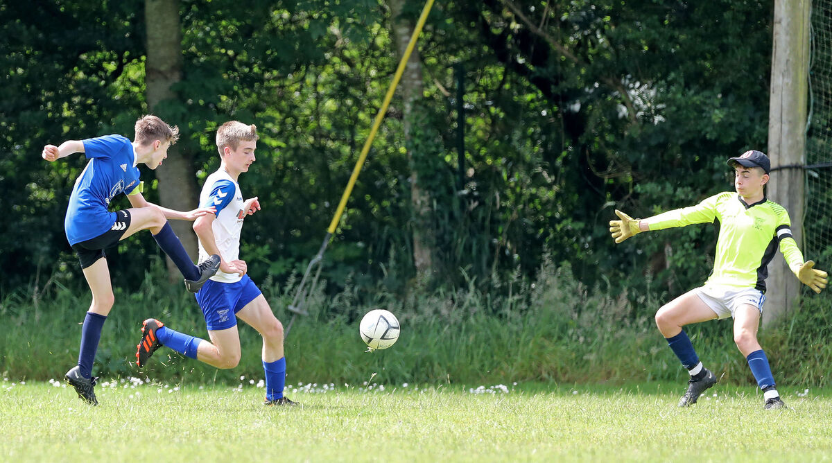 Ronan Boland, Wilton Utd, gets his shot away toi score the second goal, under pressure from Sean Murphy and Matthew Condon (goalkeeper), Corkbeg Ronan Boland, Wilton Utd, gets his shot away toi score the second goal, under pressure from Sean Murphy and Matthew Condon (goalkeeper), Corkbeg